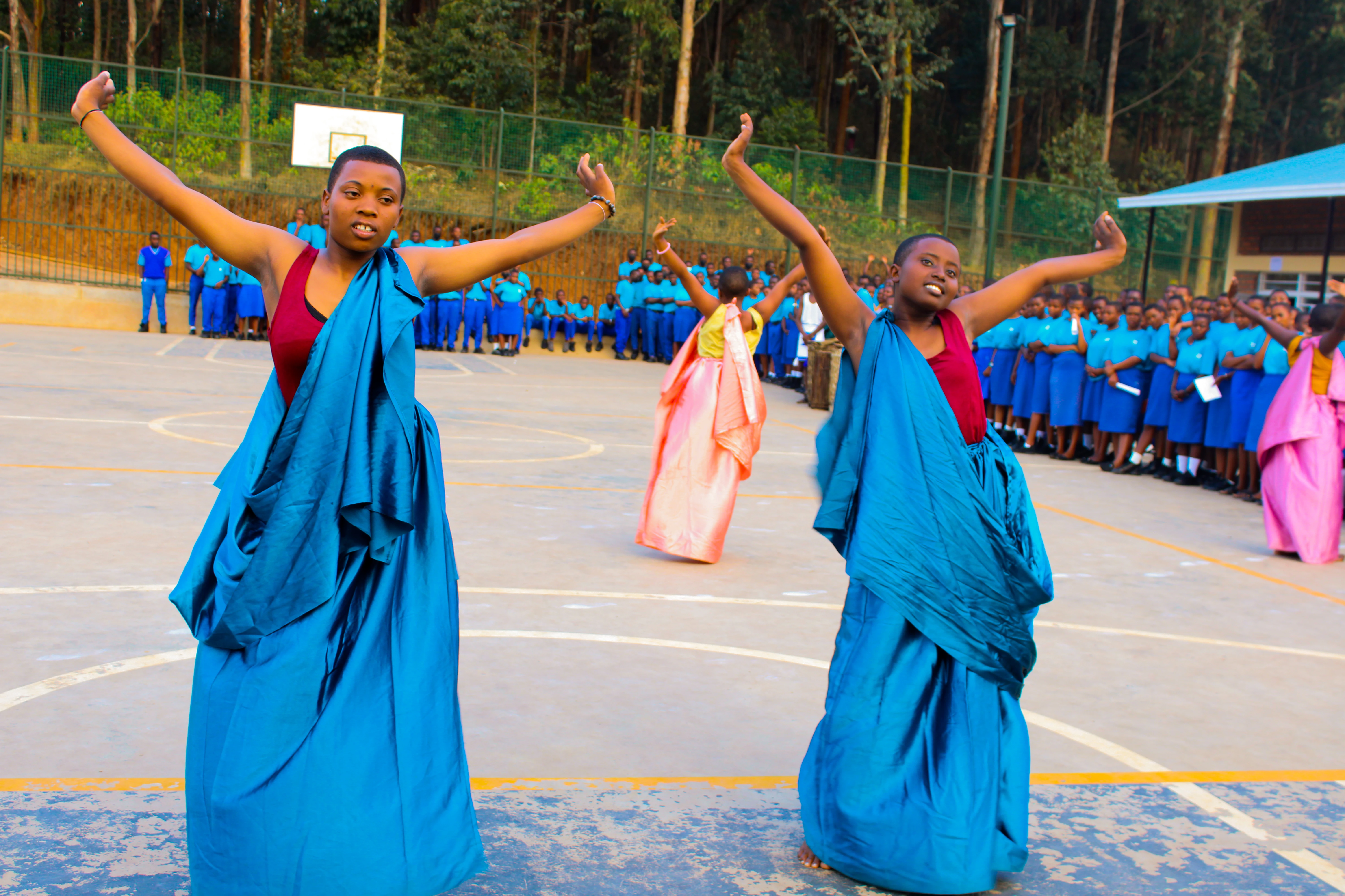 Students smiling during a dance performance
